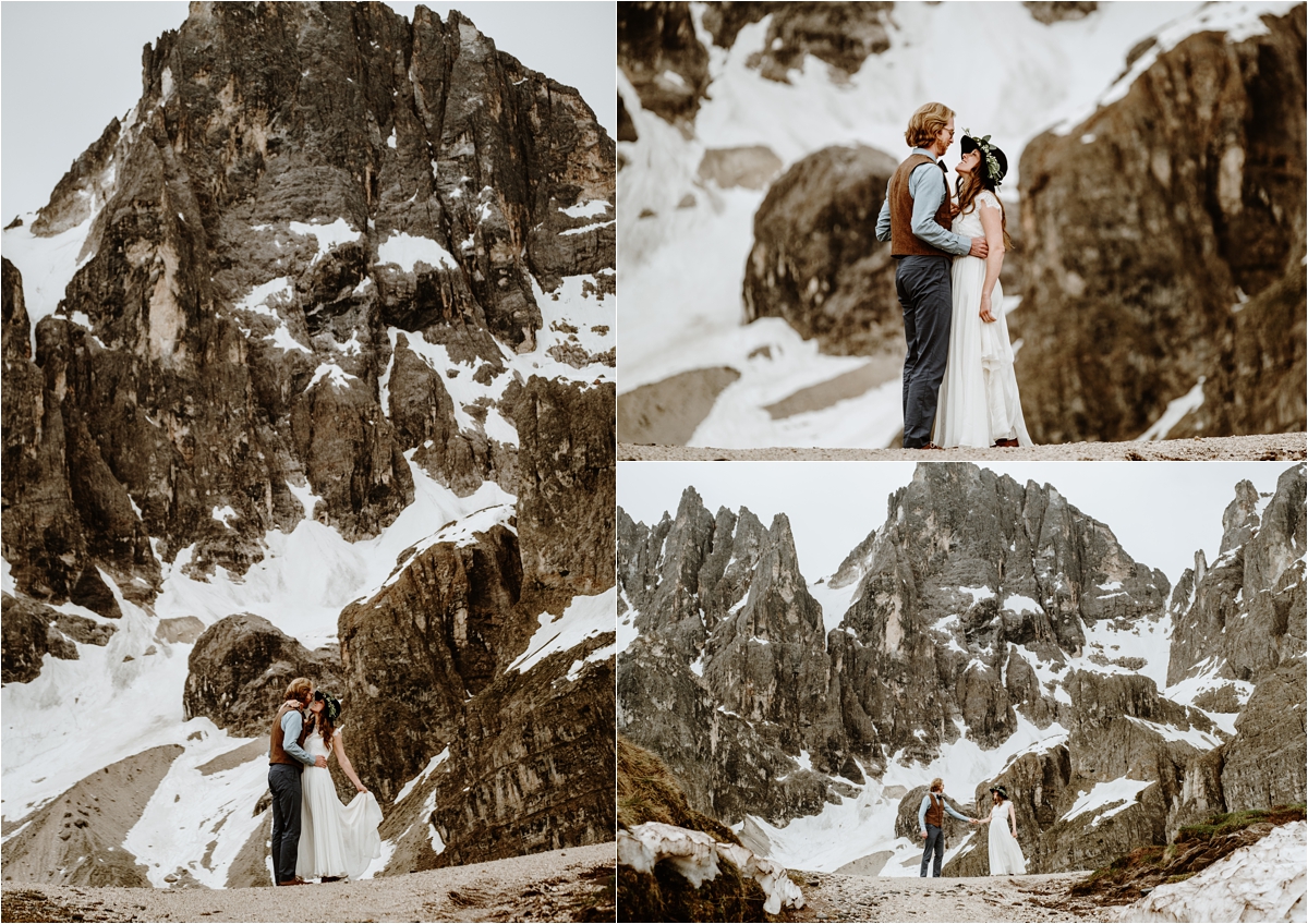 The bride and groom dance on a ridge in the Dolomites with the snow-capped mountains behind them. Photography by Wild Connections Photography