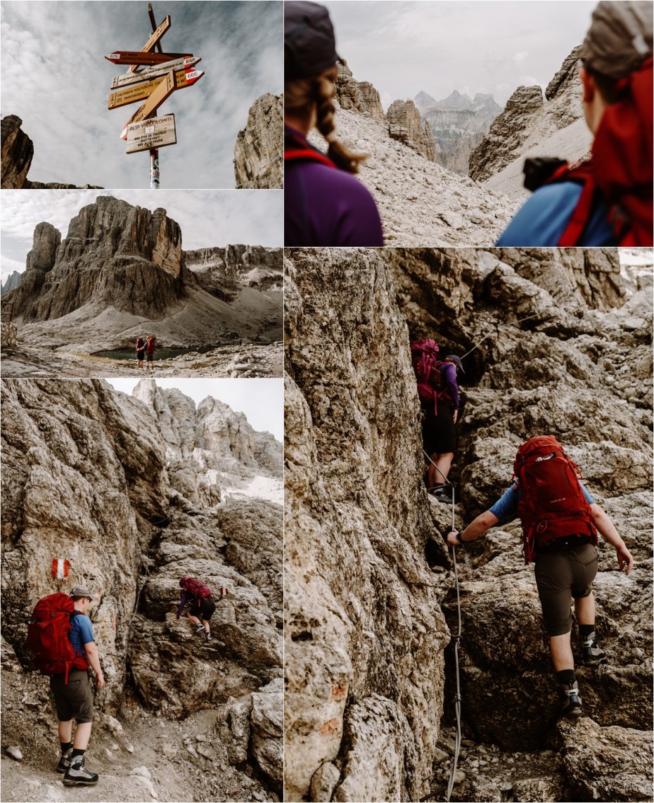 Hiking in the Dolomites for their elopement, the couples climbs up a rocky slope. Photo by Wild Connections Photography