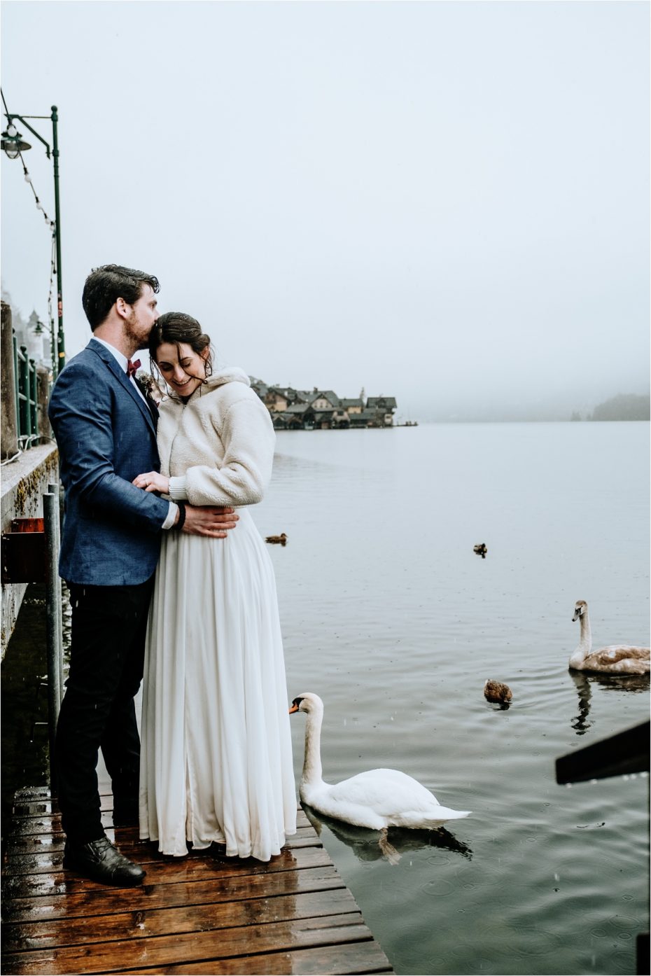 Swans swim up to the bride and groom after their Hallstatt wedding in Austria. Photos by Wild Connections Photography