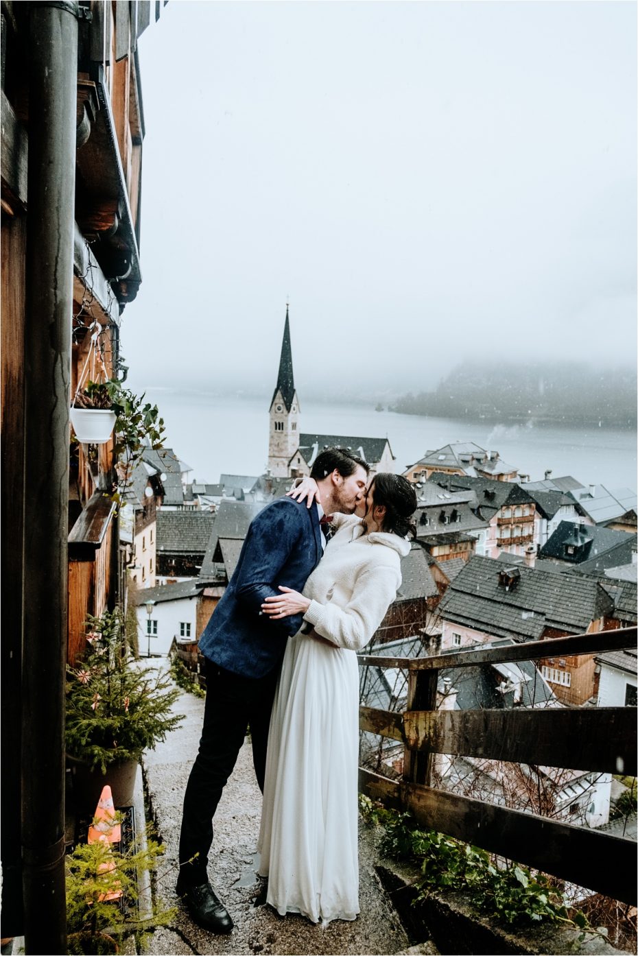 Bride and groom kiss on the steps above Hallstatt. Photos by Wild Connections Photography