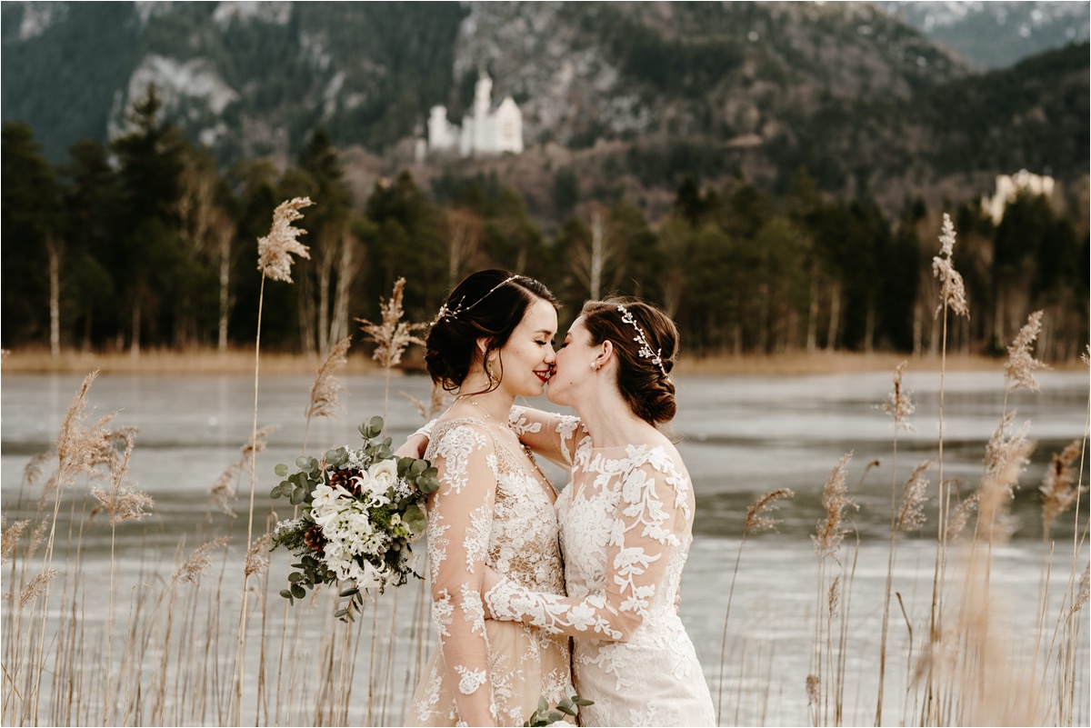 LGBT winter wedding at Neuschwanstein castle in Germany. Photo by Wild Connections Photography