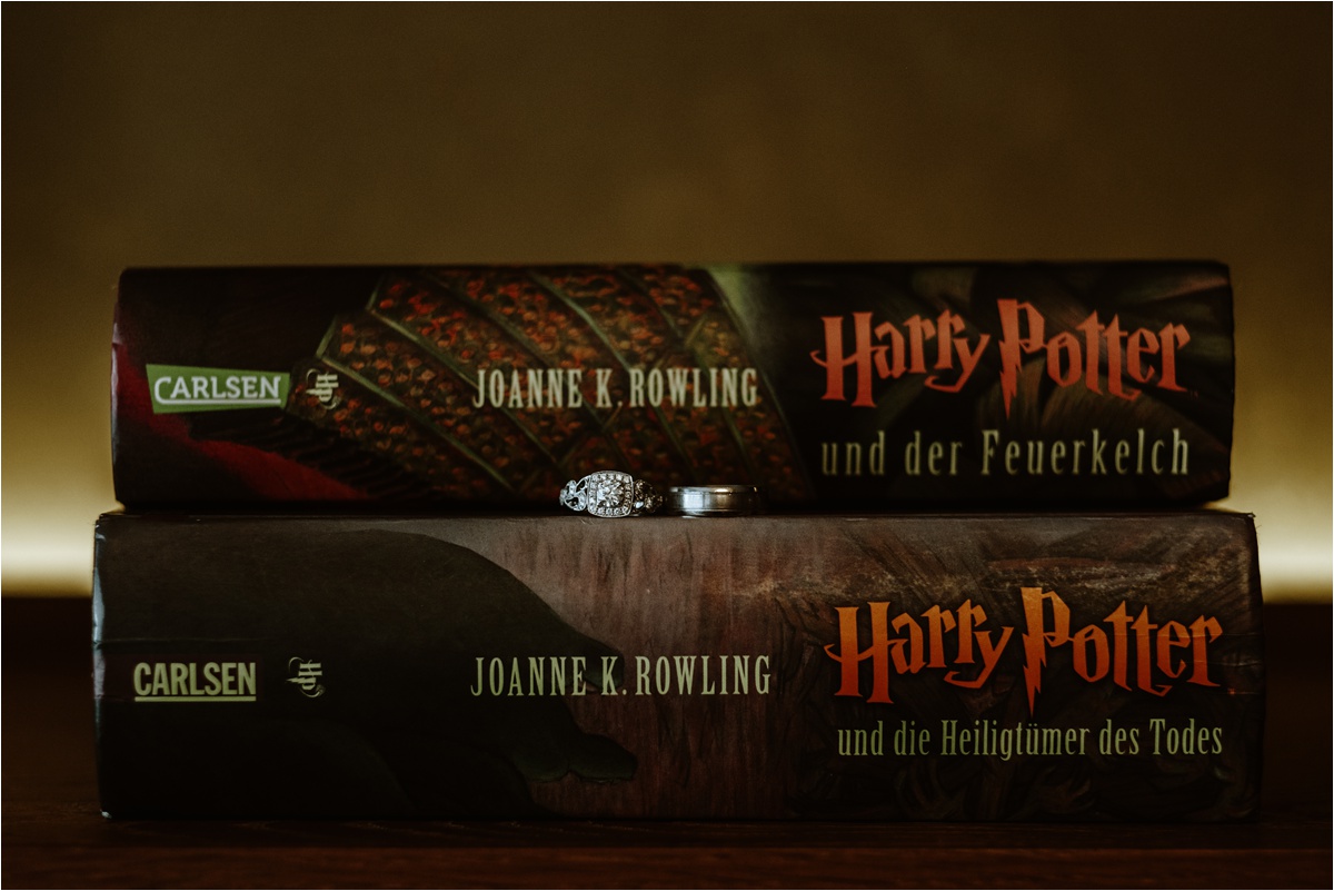 Wedding rings on Harry Potter books for this literary inspired LGBT wedding in Germany. Photo by Wild Connections Photography