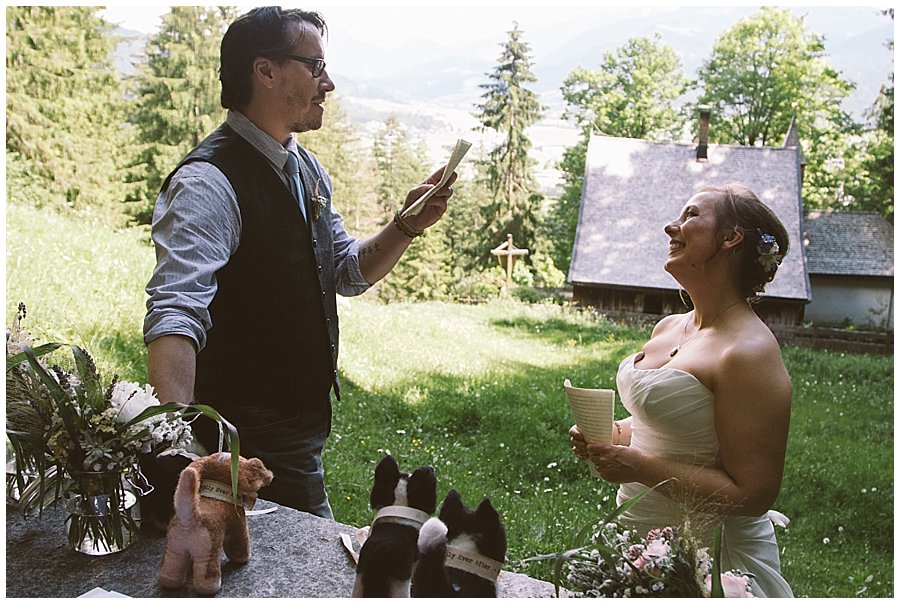 St Johann in Tirol Elopement Chris reads his vows to Nikki as she smiles at him adoringly by Wild Connections Photography