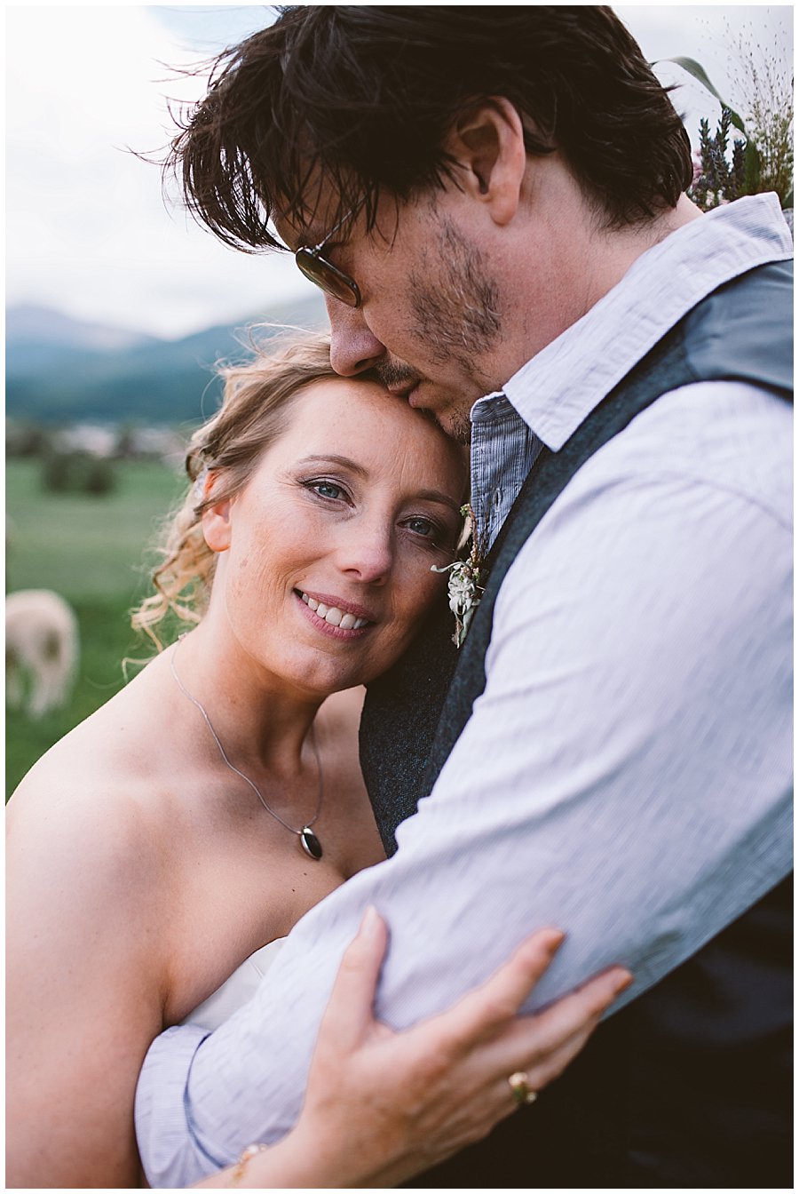 St Johann in Tirol Elopement as Nikki leans in to Chris, he kisses her on the head by Wild Connections Photography