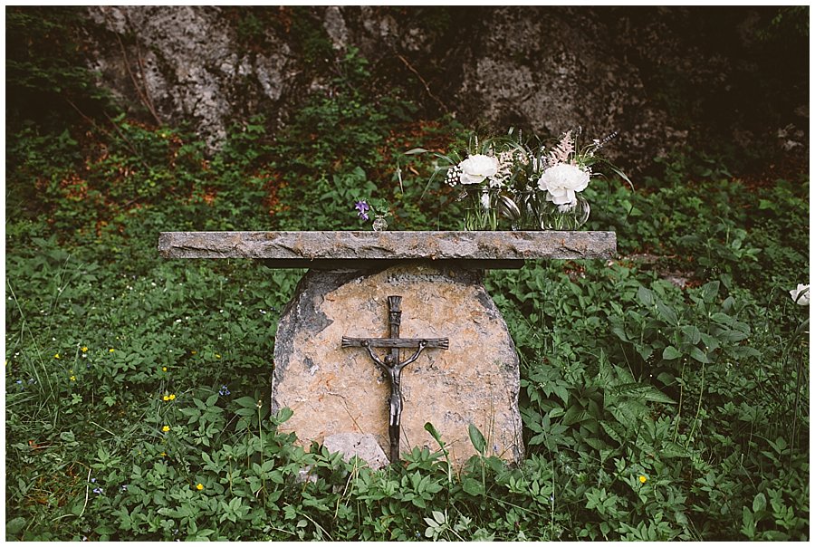 St Johann in Tirol Elopement a stone altar under a large rock face by Wild Connections Photography