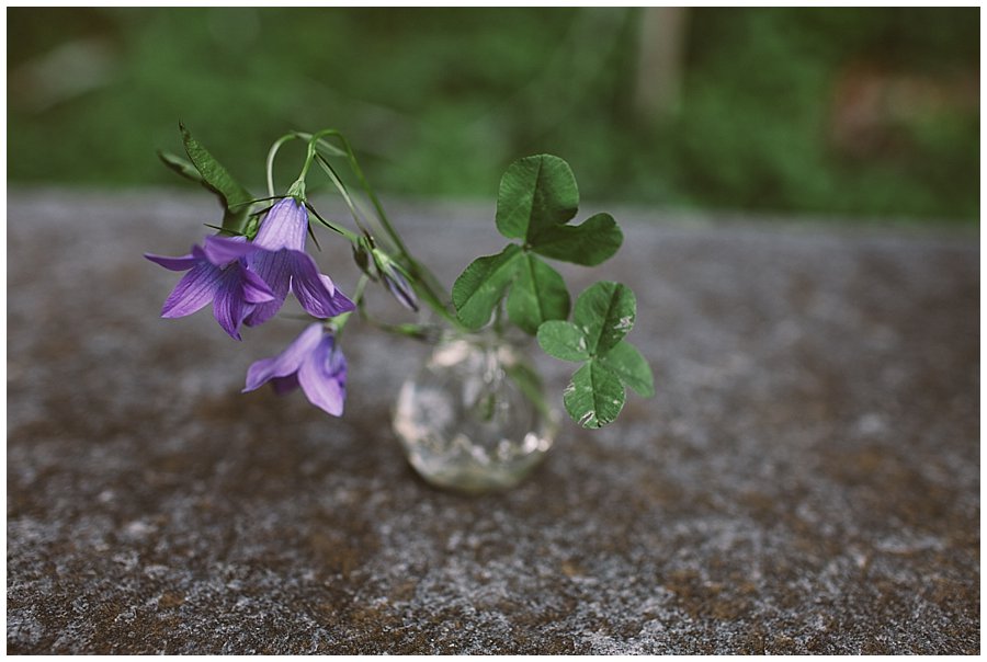 St Johann in Tirol Elopement two four-leaf clovers sit in a vase on the stone altar by Wild Connections Photography