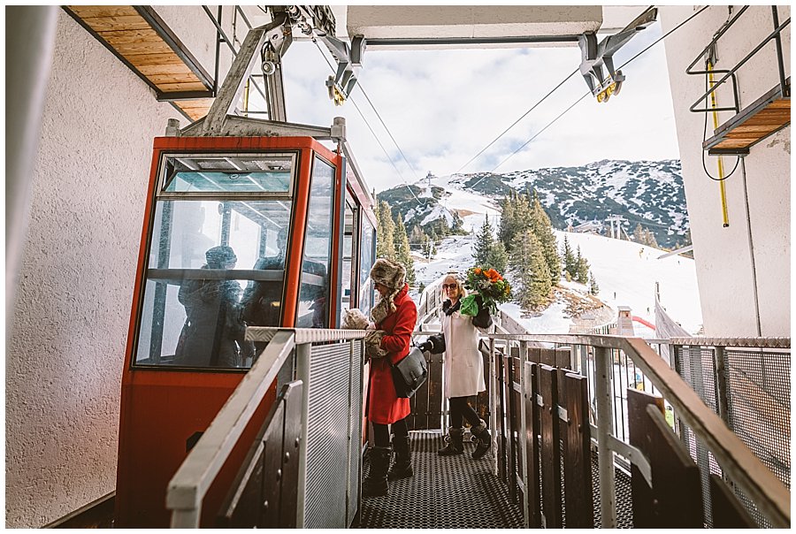 The wedding guests board the tiny vintage ski lift to the Rosshuette peak in Seefeld by Wild Connections Photography