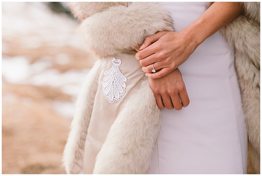 A close up of Steph's engagement ring and her fur wrap