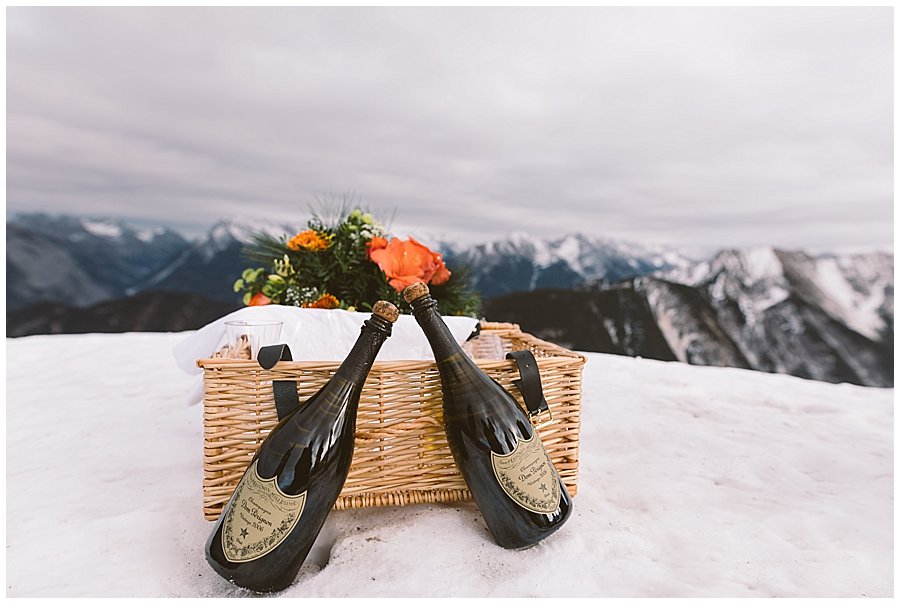 Two bottles of Dom Perignon champagne and a picnic hamper in the snow