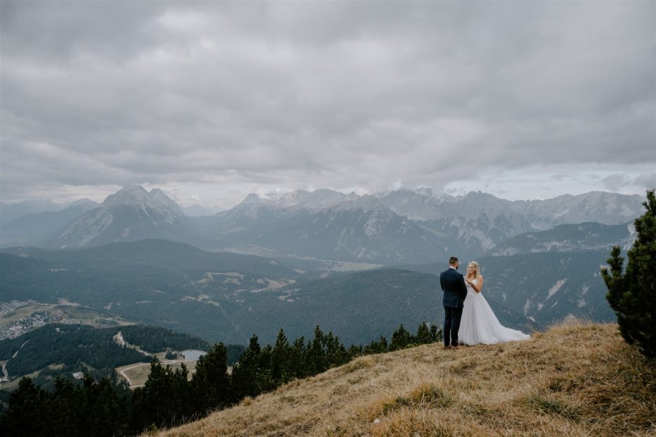 Bride and groom read wedding vows on the edge of a mountain for their Tyrol elopement