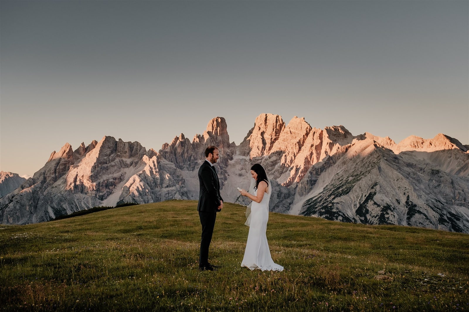Bride and groom exchange vows at sunrise in the Dolomites in Italy