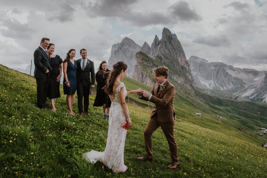 Bride and groom exchange rings in front of 5 witnesses on the Seceda mountain in the Dolomites in Italy