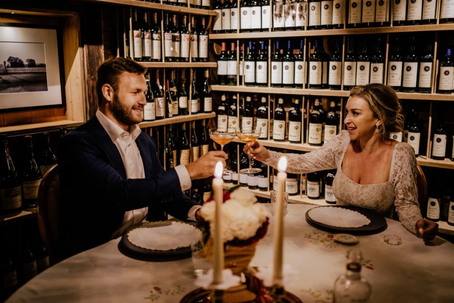 Bride and groom toast with cocktails in a michelin star restaurant in the Dolomites