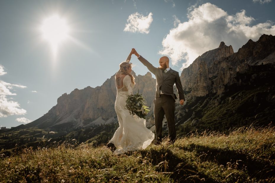 Bride and groom dance on the side of a mountain in Val Gardena in the Italian Dolomites